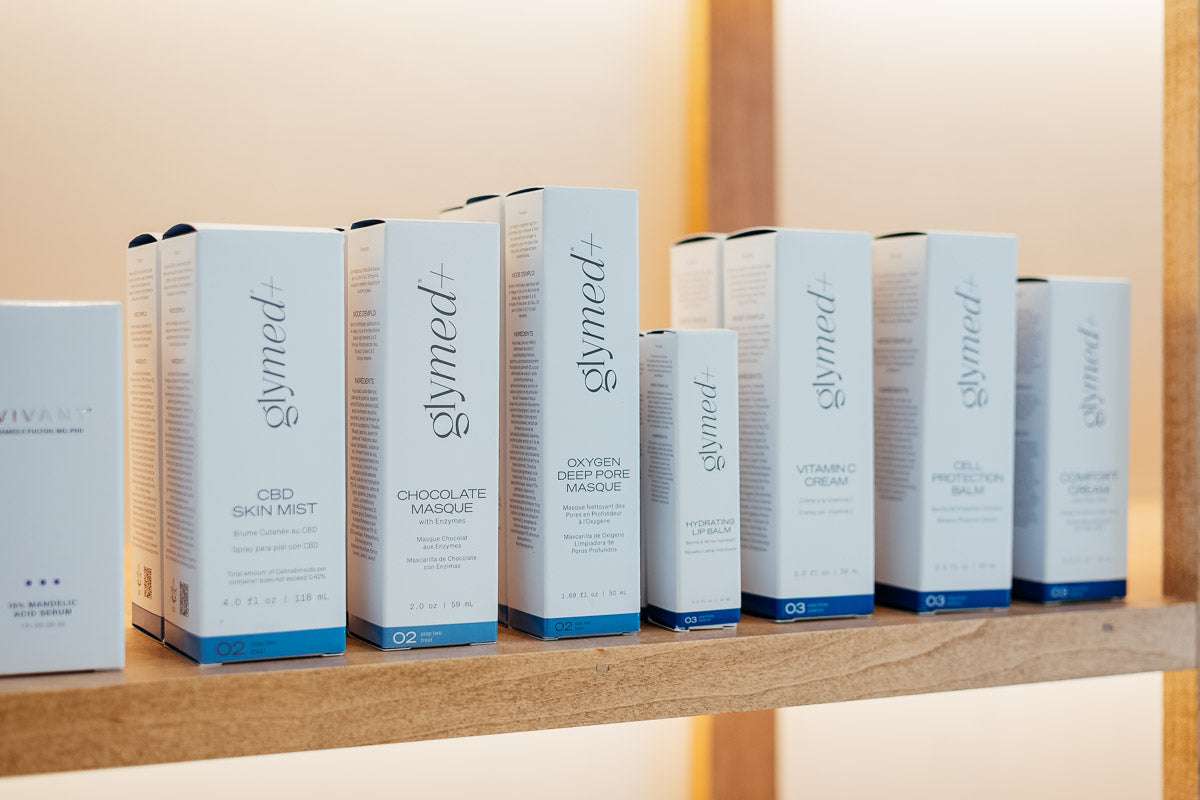 Glymed skincare flat lay with sun shine and tree shadows across them