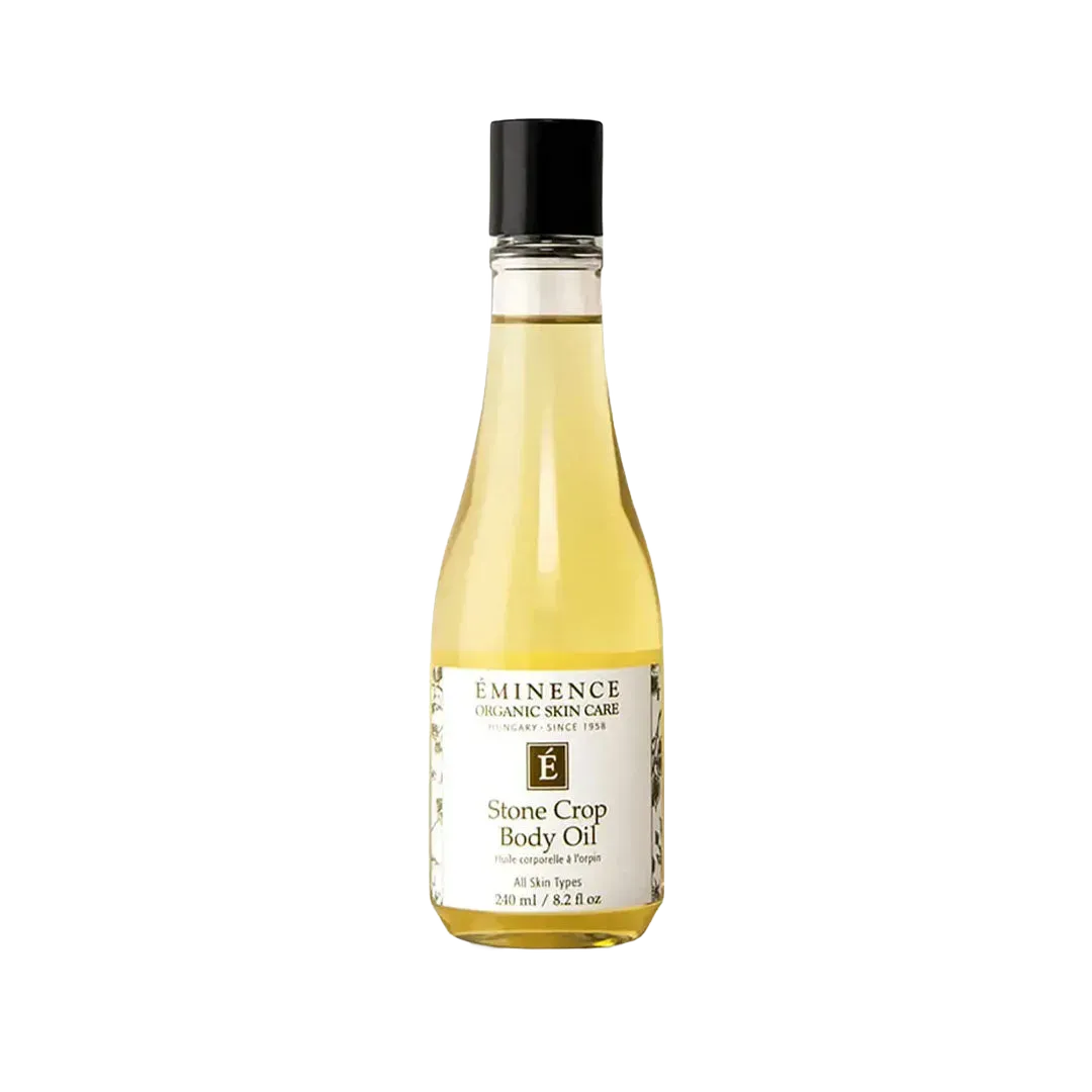 Eminence Stone Crop Body Oil in a clear 240ml glass bottle with a black cap and white label against a white background.
